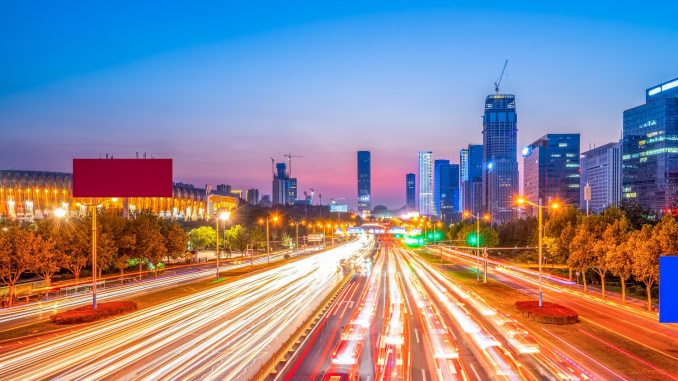 Digital Yuan Accepted on All Buses Vehicle lights on an urban road in Jinan, China.
